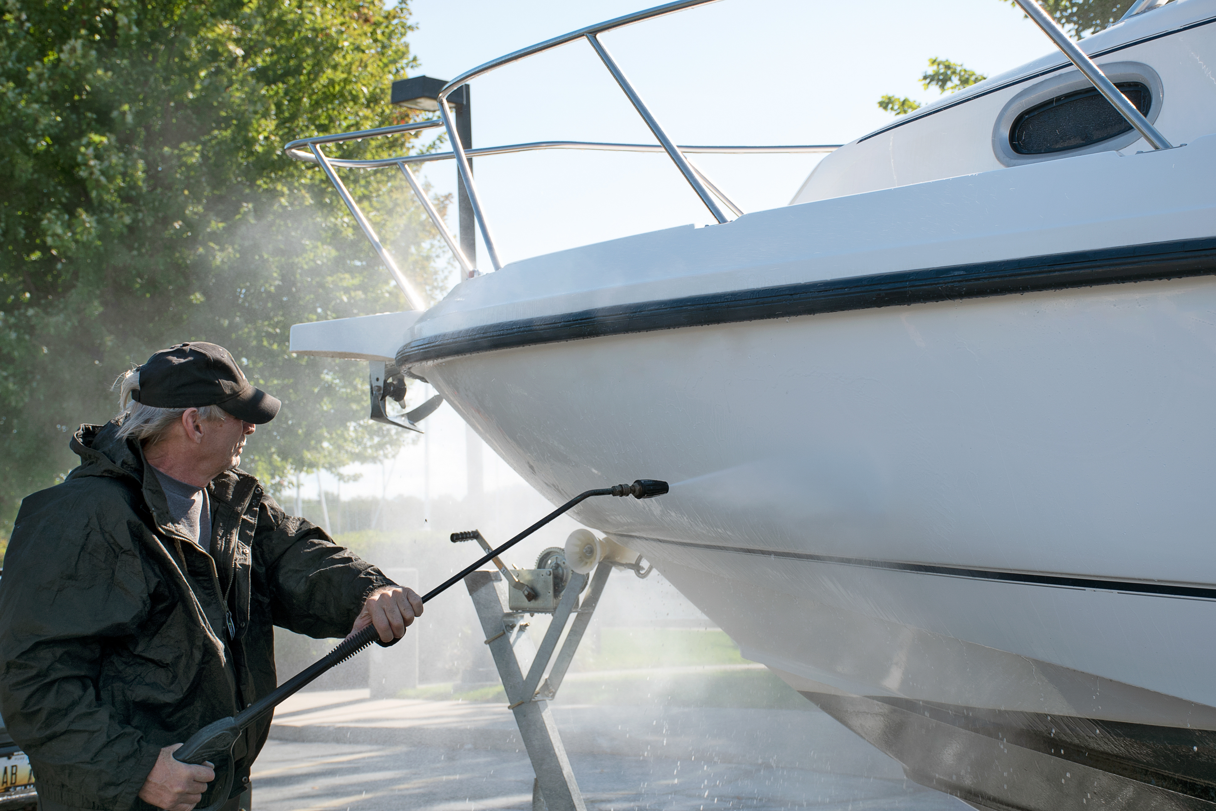 Man pressure washing the Boat