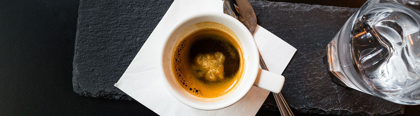 1440 by 400 pixels combination systems banner, cup of coffee and glass of iced water on the table, commercial website