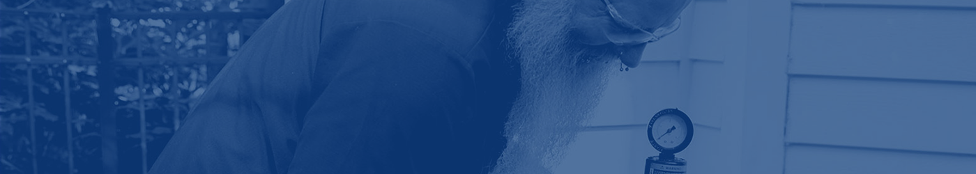 A man working on a filter cartridge. Blue overlay.